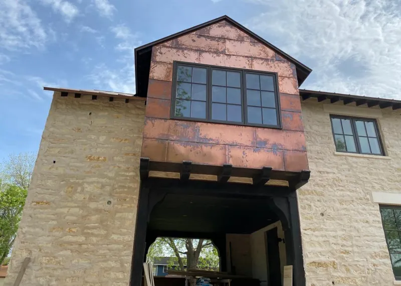 Copper metal panel facade on a stone building for Roof Repair in Krum