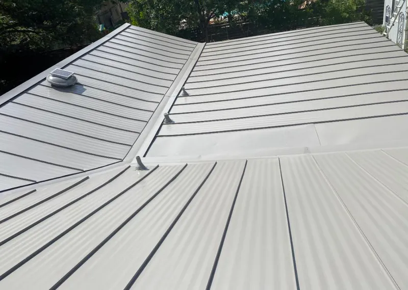 Solar attic fan installed on a metal roof for Roof Ventilation in Krum